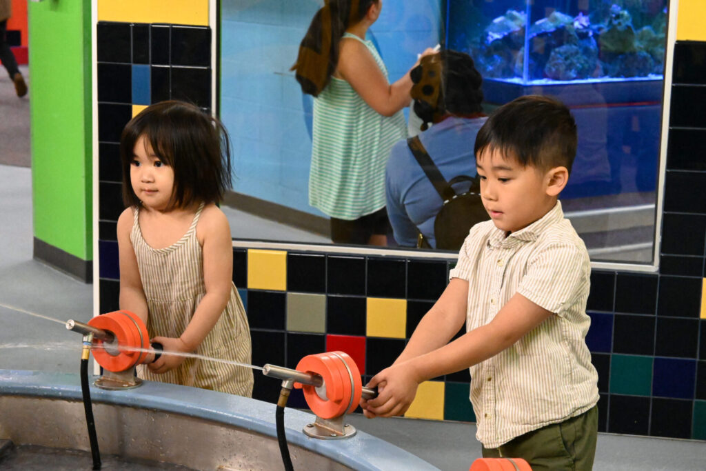 Children exploring the water exhibit at Building for Kids
