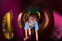 Child crawling through the play tunnels at Cactus Jack's Playhouse.