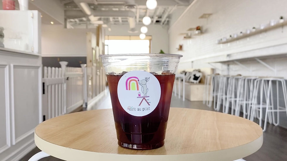 Coffee and seating area at Café Au Plait with the playspace visible nearby
