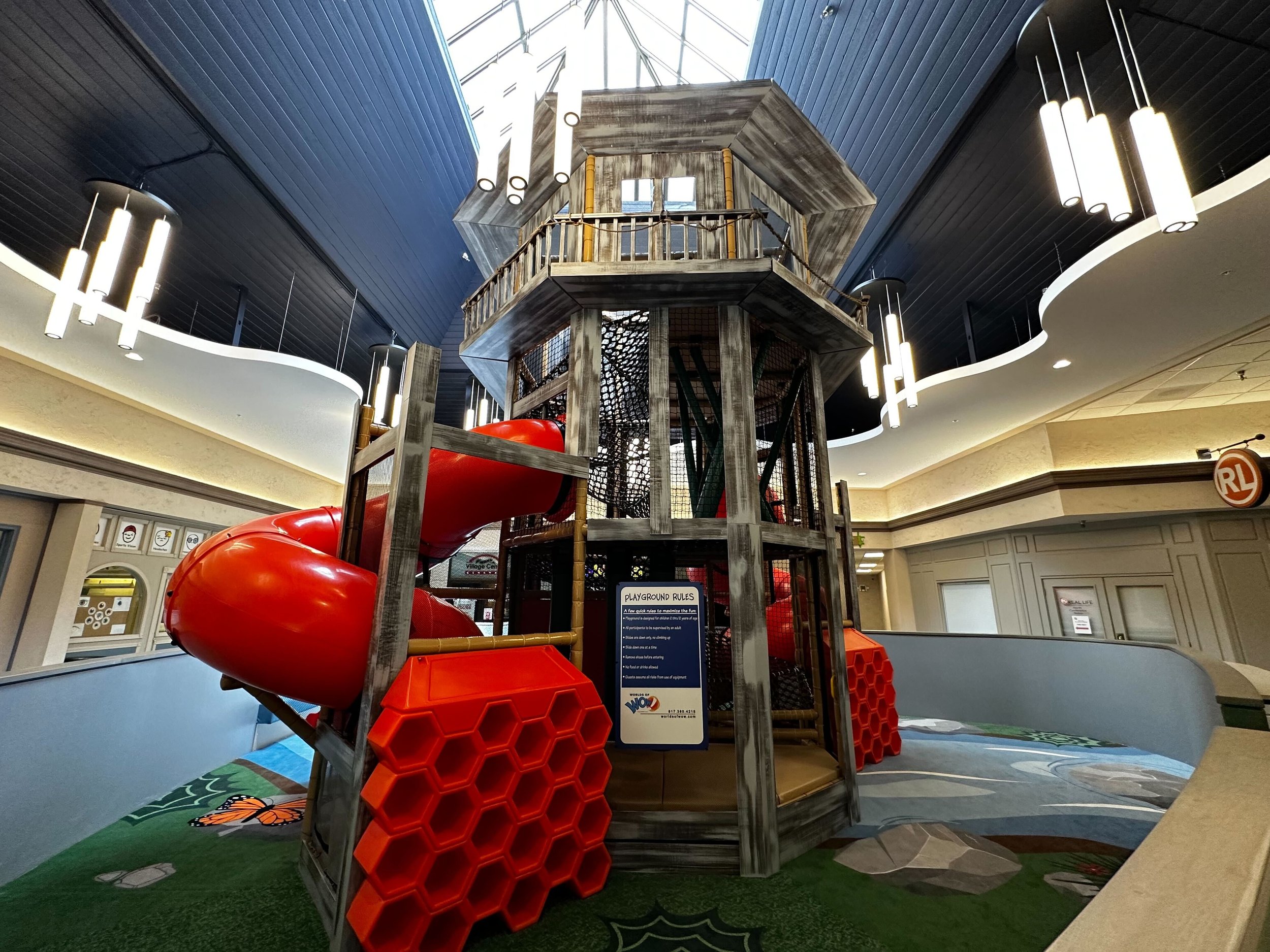 Wide view of the treehouse play structure at Cedar Creek Play Land.