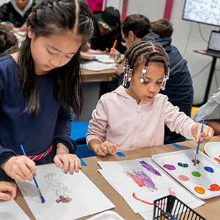 Children participating in a guided art or program activity at CMOM.