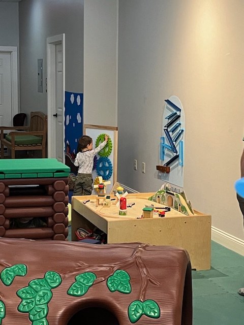 Interactive wall toys and table play inside the Children's Museum of the Northeast Kingdom.