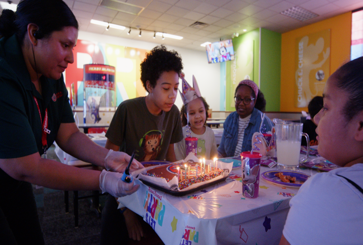 Birthday table setup during a sensory-sensitive celebration at Chuck E. Cheese.