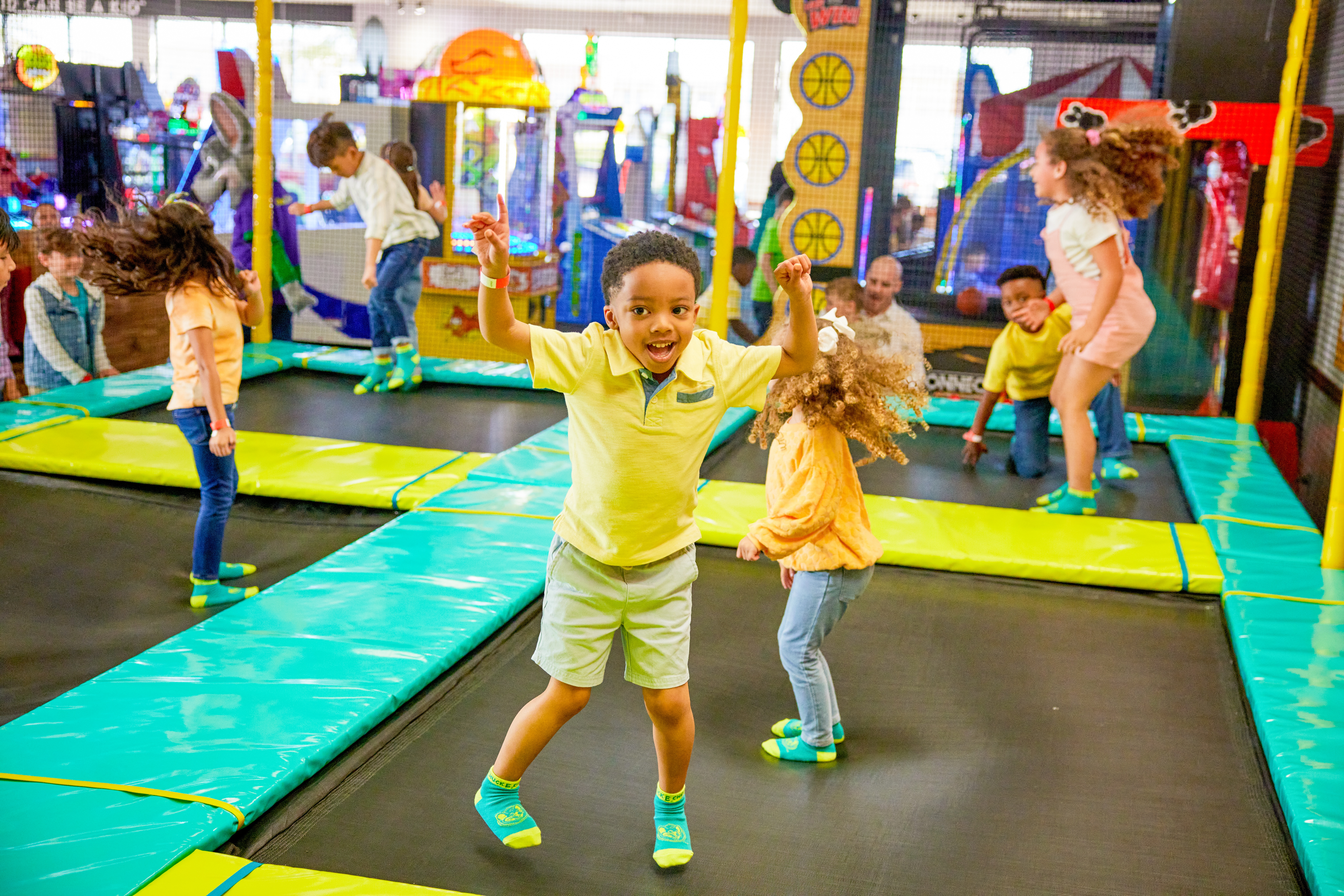 Kids jumping in the trampoline zone at Chuck E. Cheese