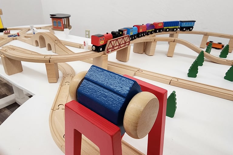 Train table and hands-on play setup inside Coos Playtopia.