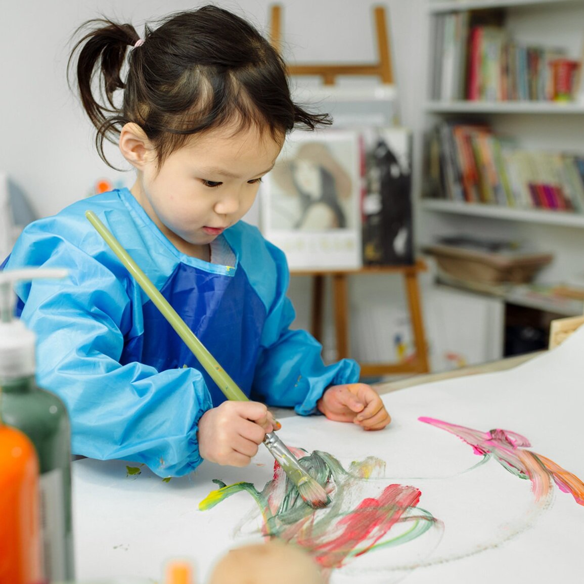 Child painting during an activity at Create & Play Kids.