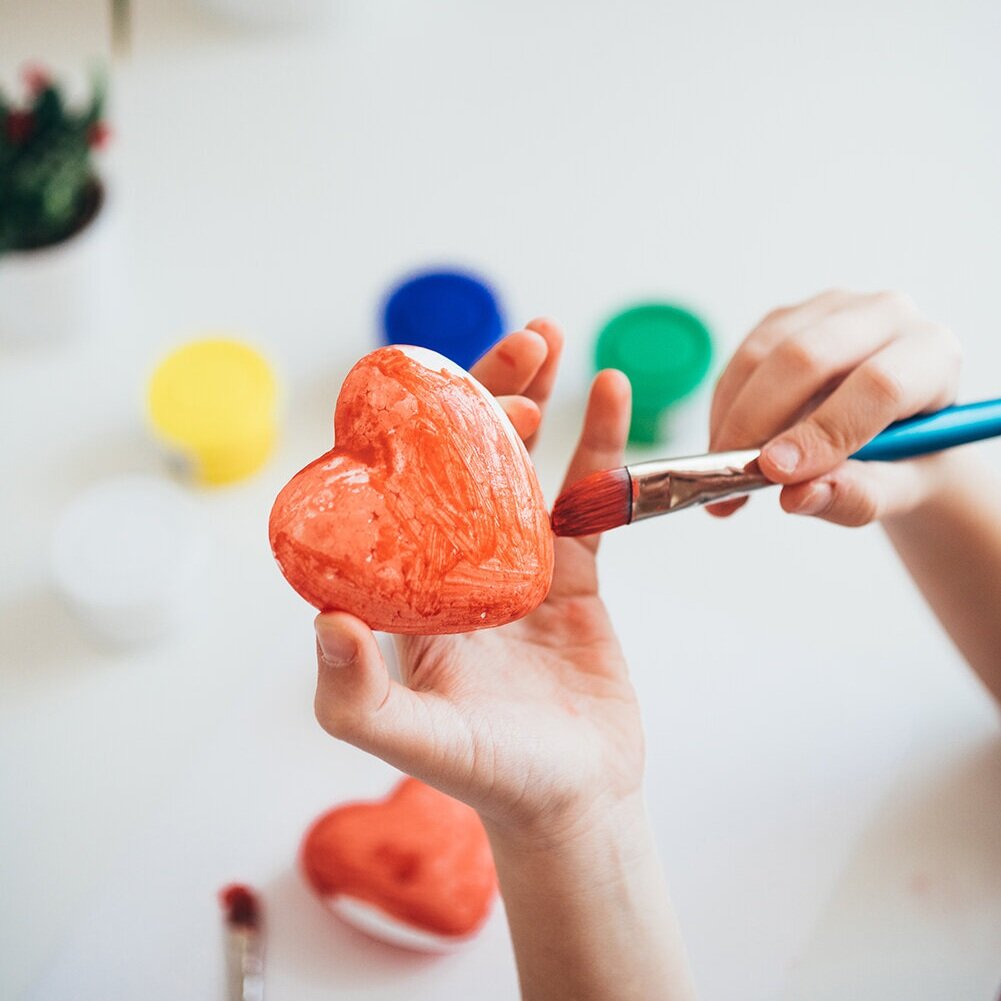 Close-up of a child painting a craft at Create & Play Kids.