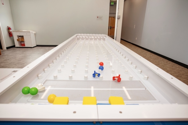 Children playing at Curiosity Place's water table exhibit.