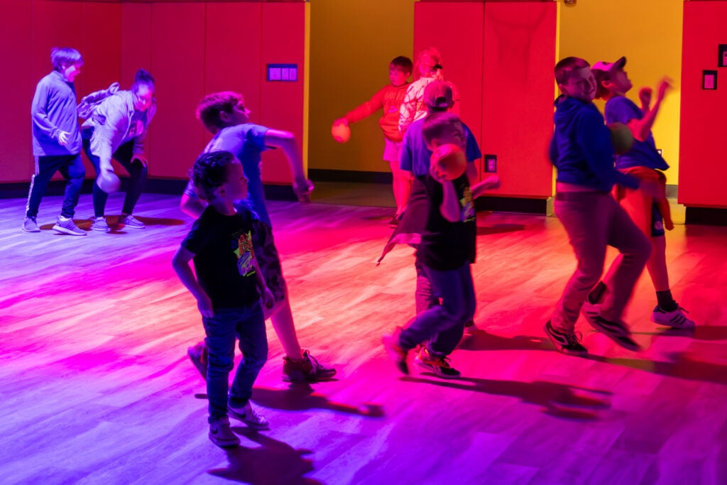 Kids playing in the Lu Digital Interactive Playground at the Discovery Center.