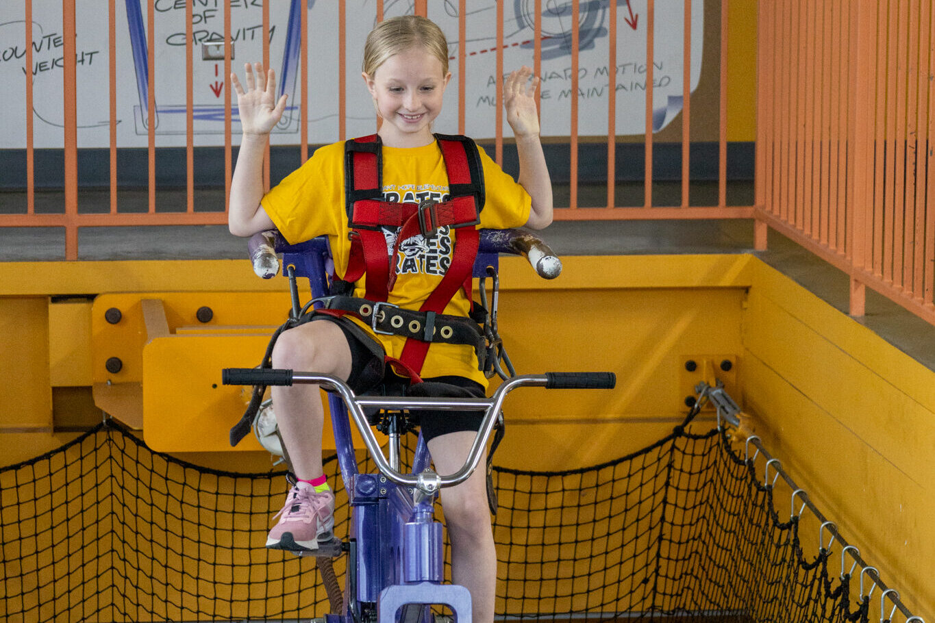 Child riding the HighWire Bike at the Discovery Center.