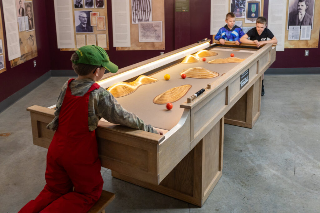 Children playing at the TerraBall table exhibit at the Discovery Center.