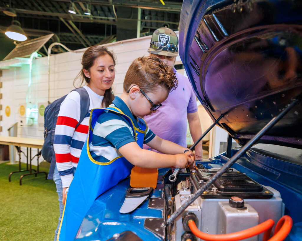 Child exploring the mechanic exhibit at Discovery Gateway