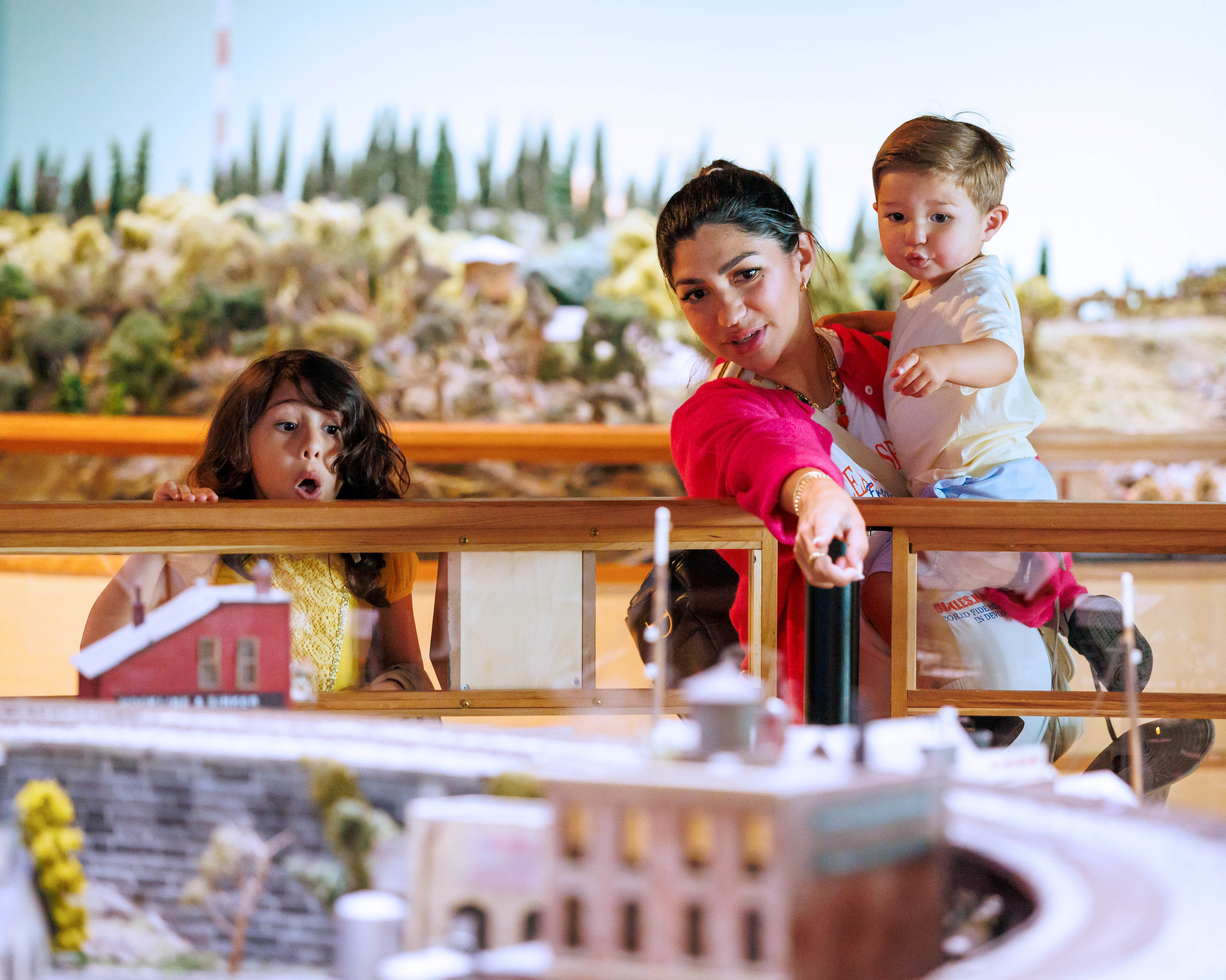 Family viewing the railroad exhibit at Discovery Gateway