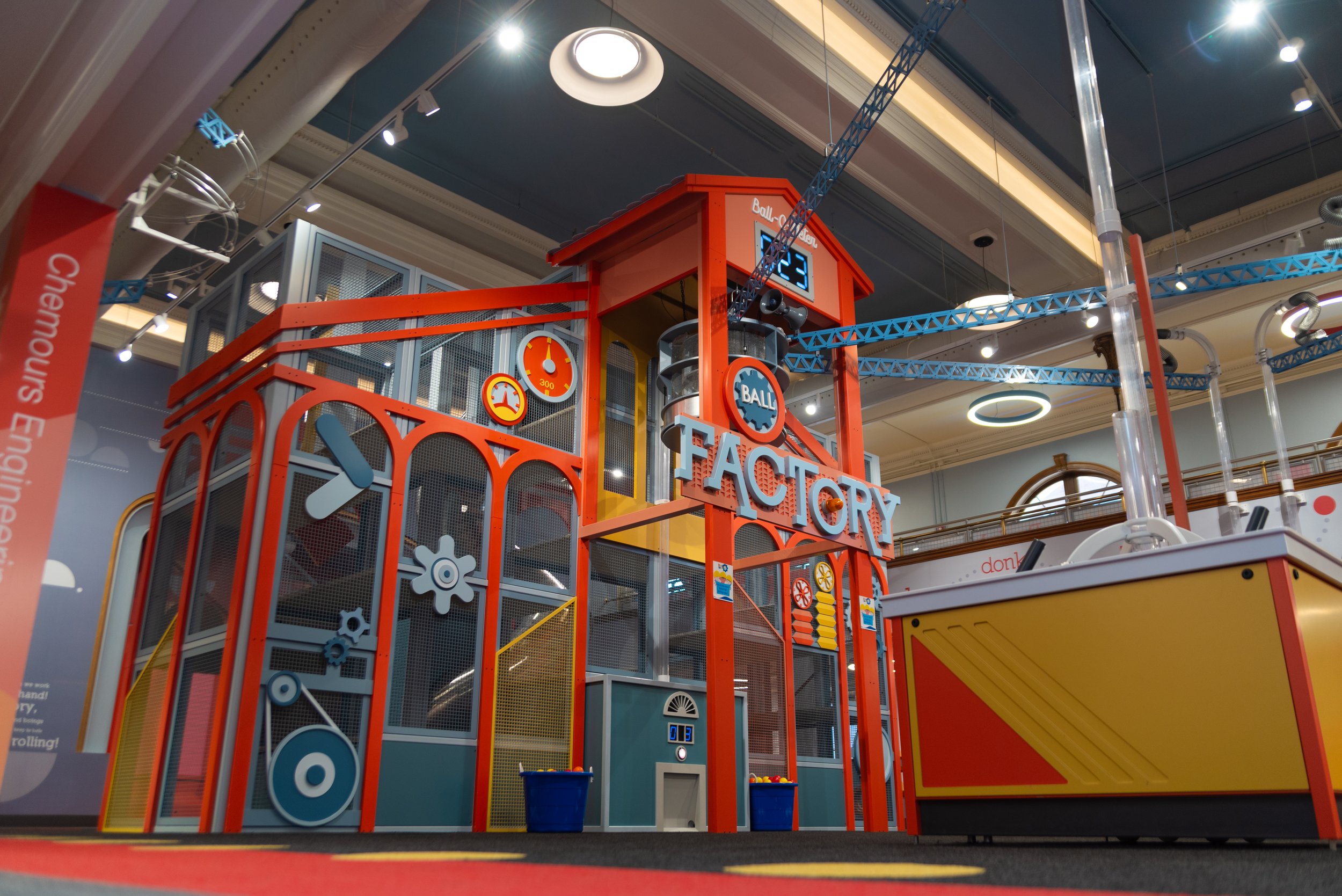 Children climbing and playing in the Ball Factory area at Discovery World on Market