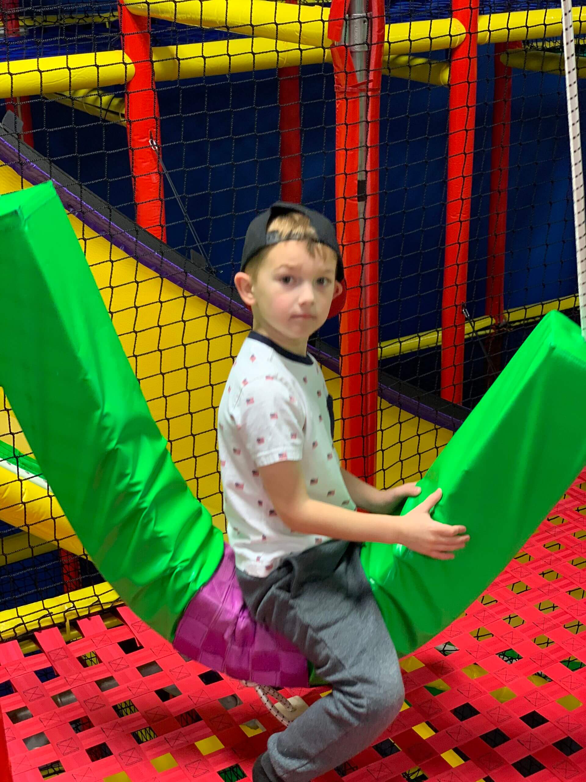 Colorful indoor climbing and slide area at Discovery Zone Florence Mall.