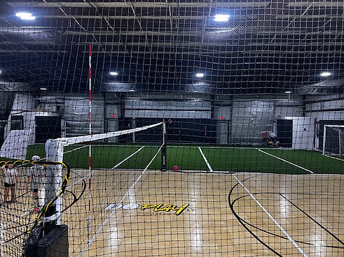 Sports court and turf area inside Do Play's larger activity space.