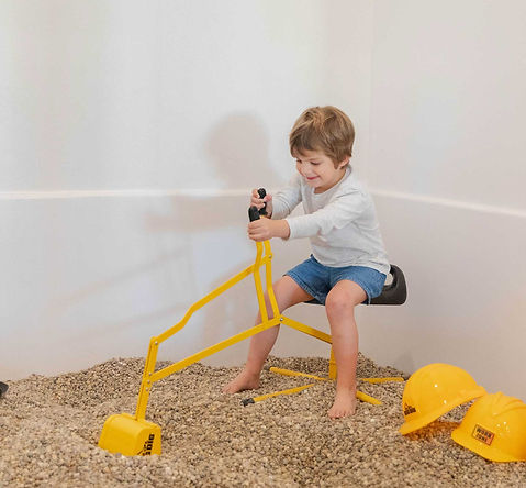 Child using construction-style sensory play at Dorothy's Playhouse.