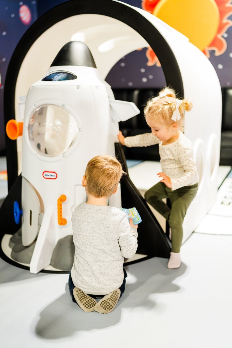 Kids inside a rocket-themed play feature at Enchanted Natomas