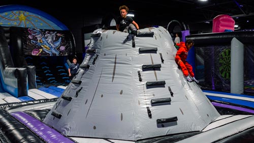 Children using the climbing wall area at Epic Fun Park