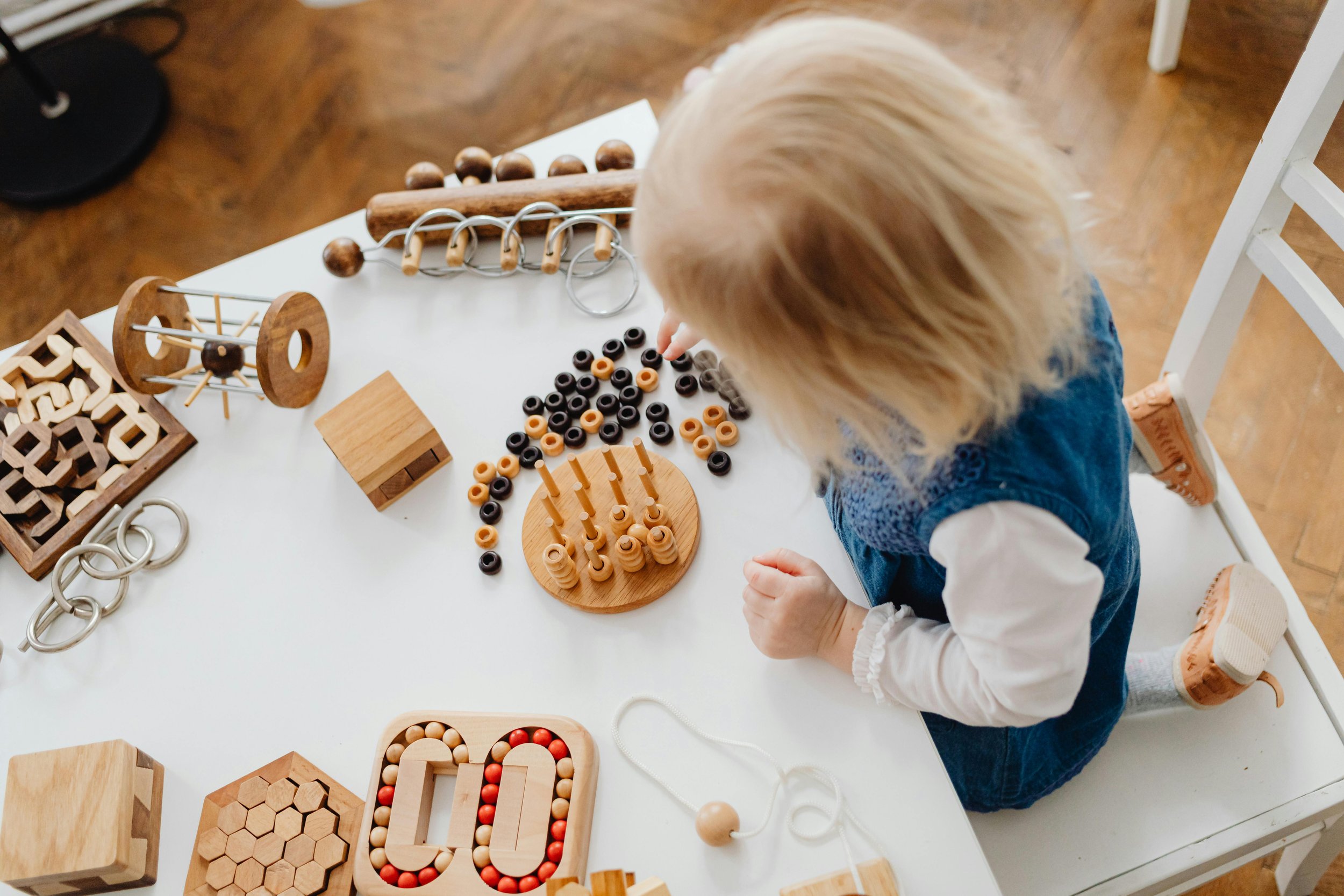 Toddler exploring tabletop toys at EverPlay Village.