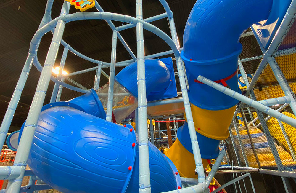 Slides and upper-level indoor play elements at Exhilarate Savannah