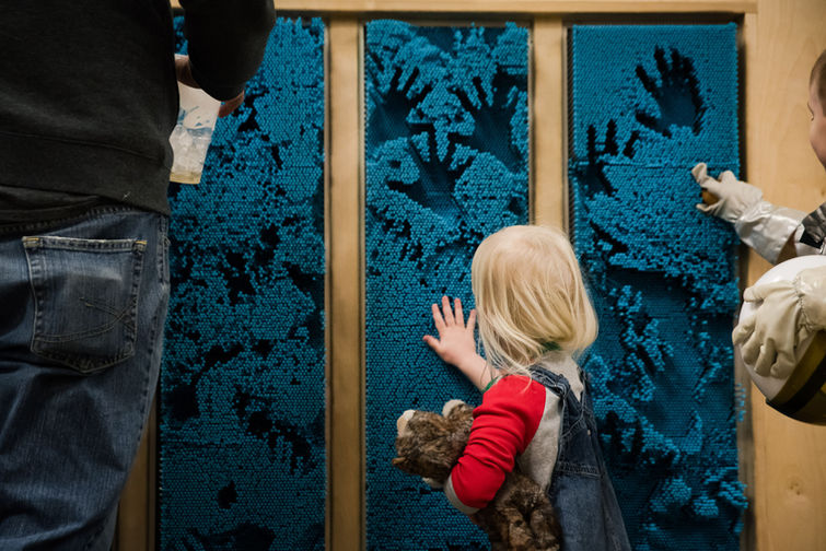 Children and adults interacting in the Fairbanks Children's Museum.