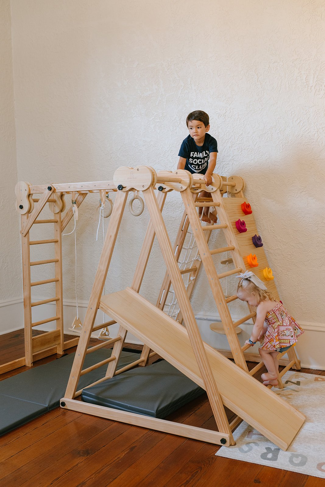 Child using indoor climbing equipment at Family Social Club