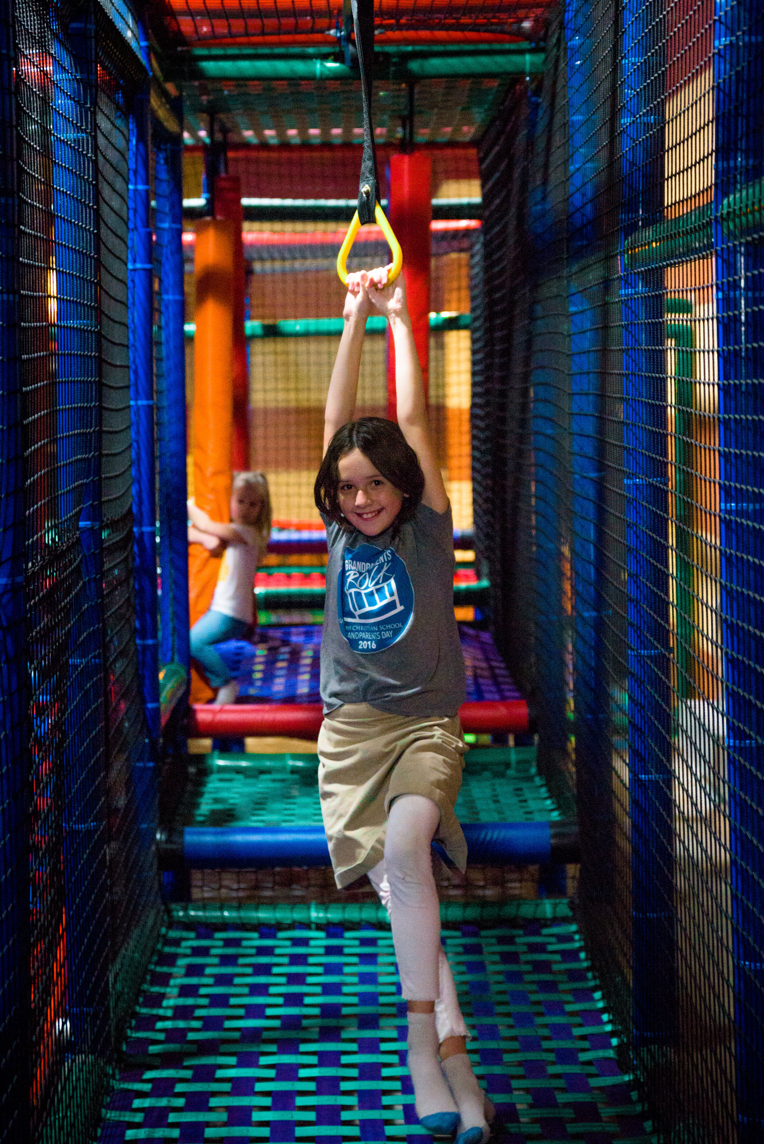 Child crossing obstacle elements inside the Fast Lane play structure
