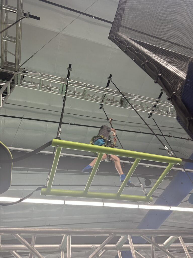 Child crossing the elevated ropes course at Flying Giant Adventure Park.