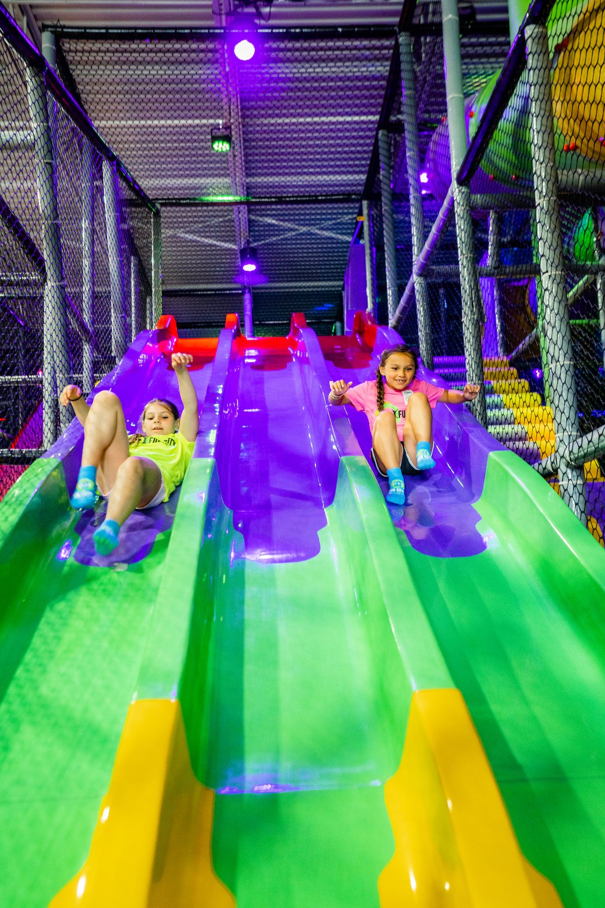 Kids bouncing on connected trampolines at Fun City Adventure Park Bear.