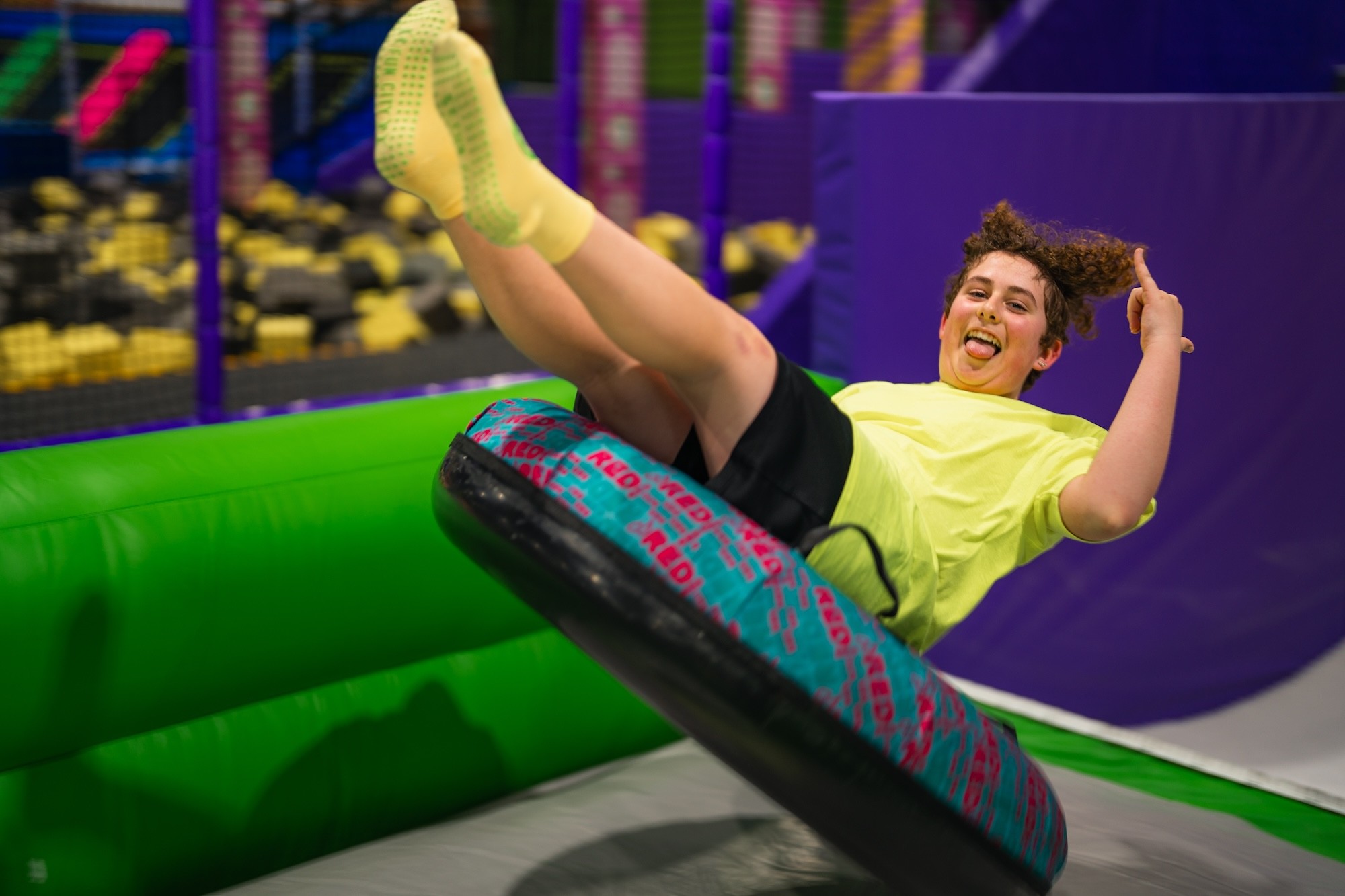 Rider on a spinning tube attraction inside Fun City Adventure Park