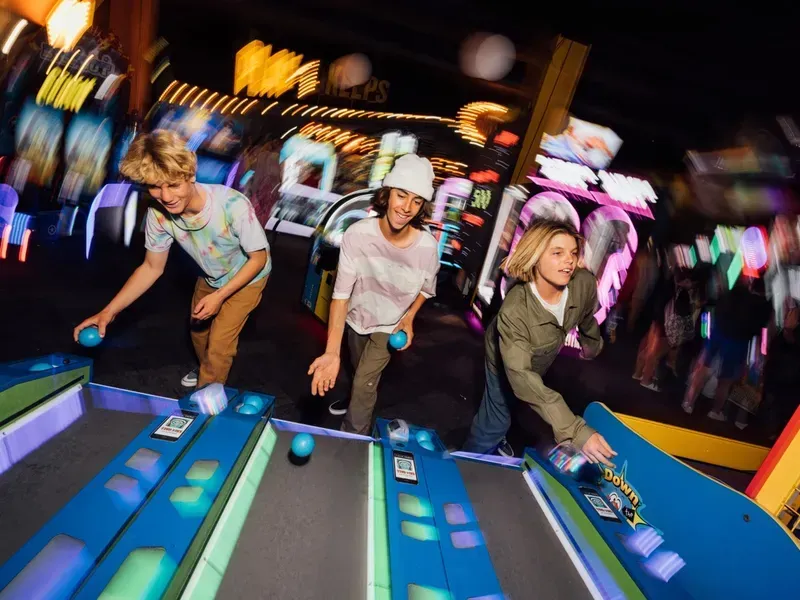 Kids playing arcade games at Fun Factory Kona Coast.