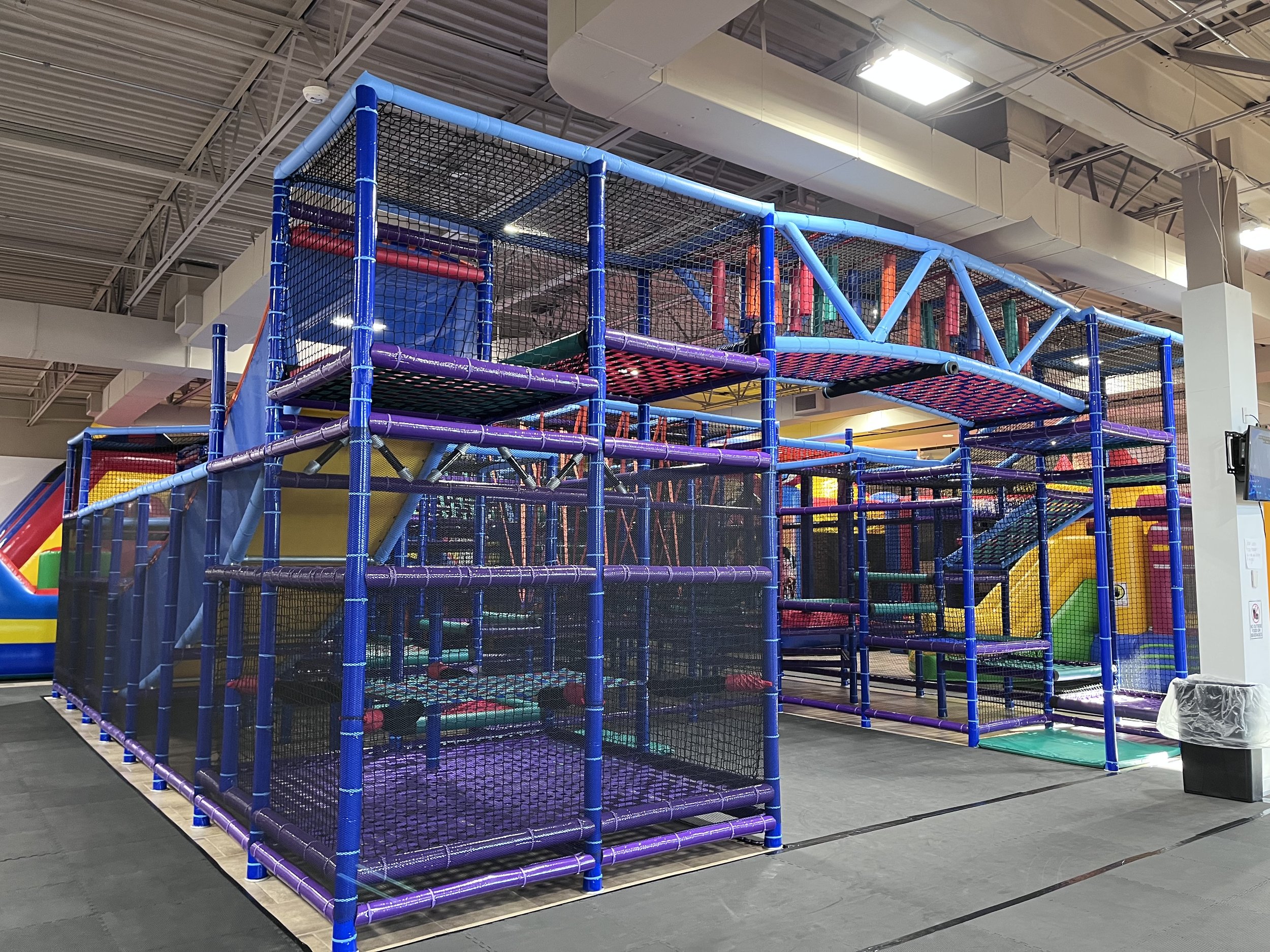 Main indoor play floor at Fun Run St. Joe with inflatable attractions.