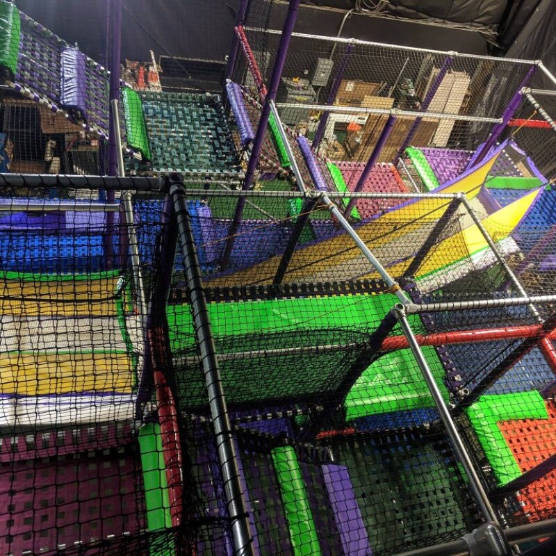 Children moving through the multi-level Sky Maze play structure.