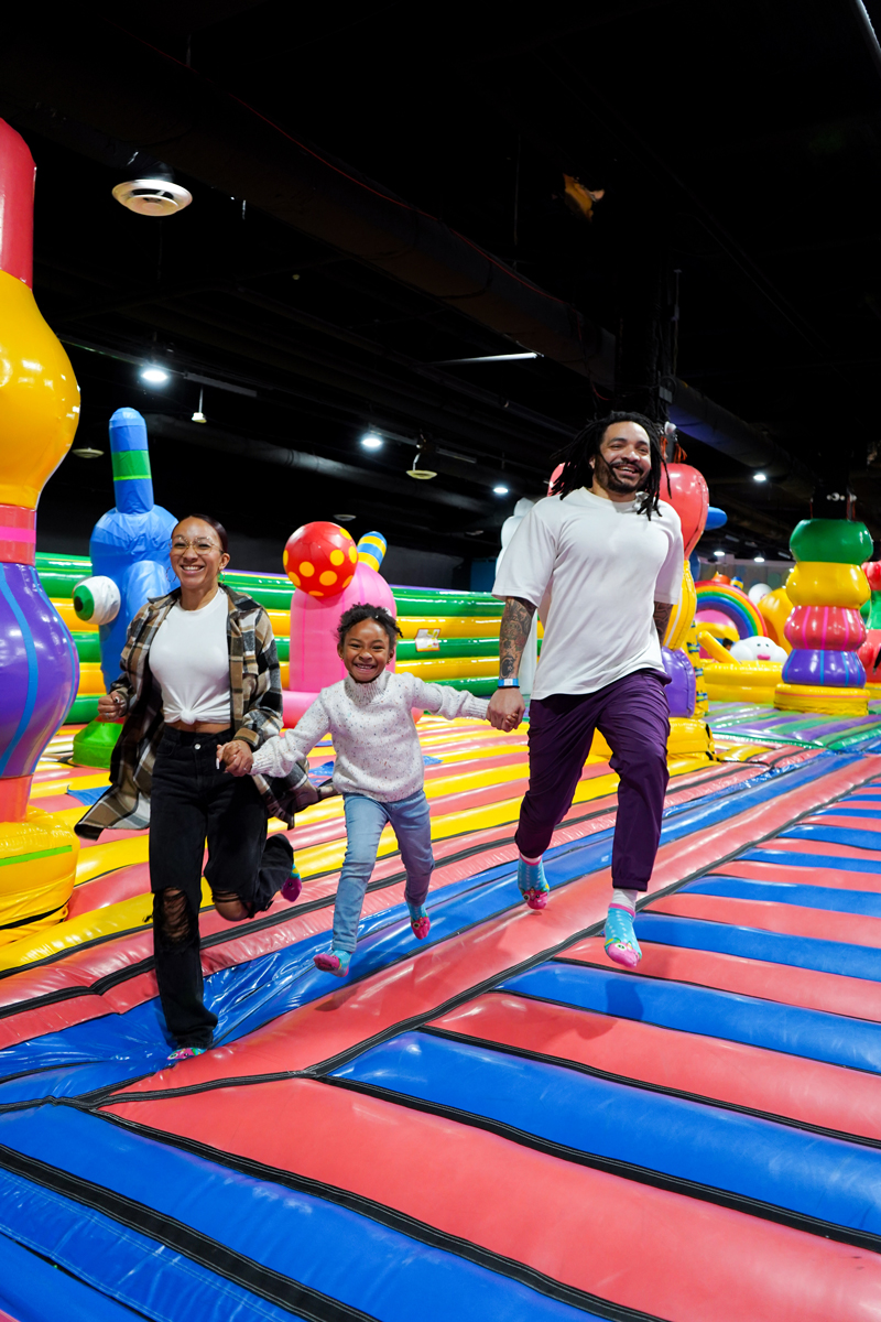 Family moving through a bounce obstacle course