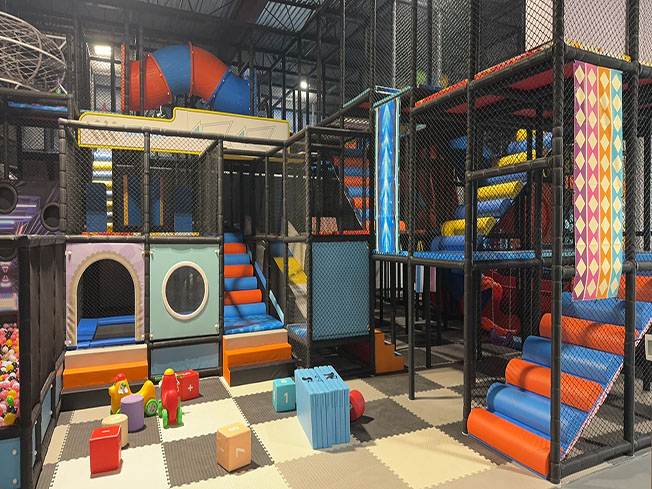 Multi-level playground structure inside Funplex Trampoline Park in Hampton.