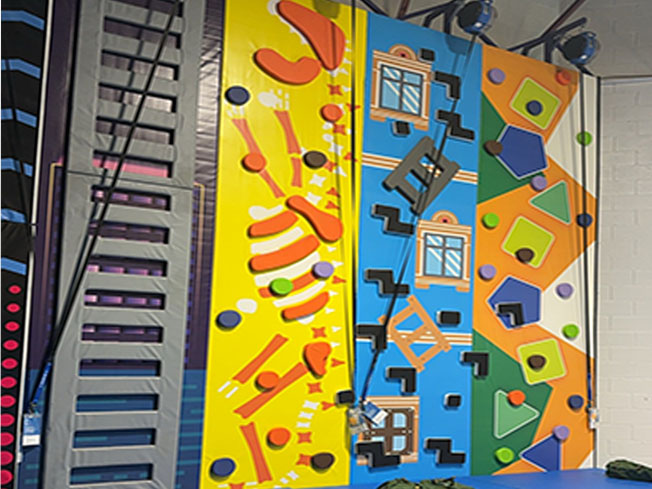 Colorful climbing wall at Funplex Trampoline Park in Hampton.