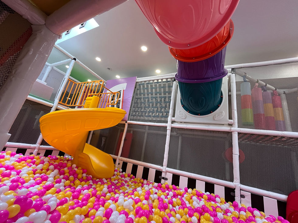 Ball pit, yellow slide, and colorful indoor play structure inside Funtopia.