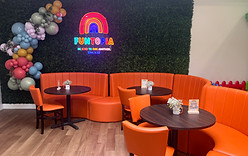 Orange booth seating and lounge area inside Funtopia.