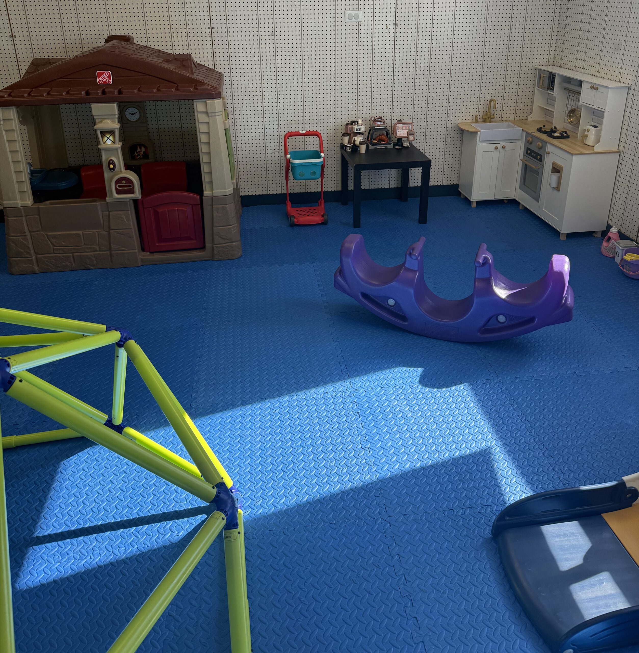 Pretend play kitchen and playhouse inside Garden City Fun Zone