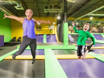 Parent and child jumping together on the trampoline court at Get Air Harrisburg.