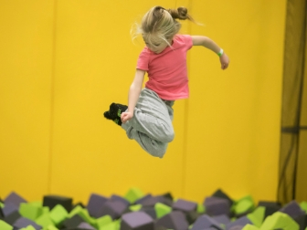 Child jumping toward a foam pit at Get Air Palm Desert.
