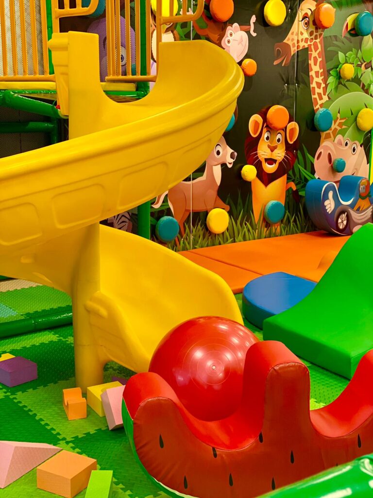 Colorful Go Playland play structure with climbing and slide features.