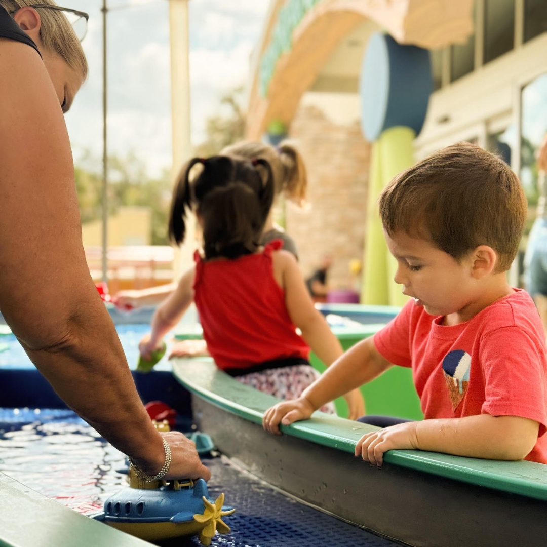 Young child playing at a CMON water exhibit.