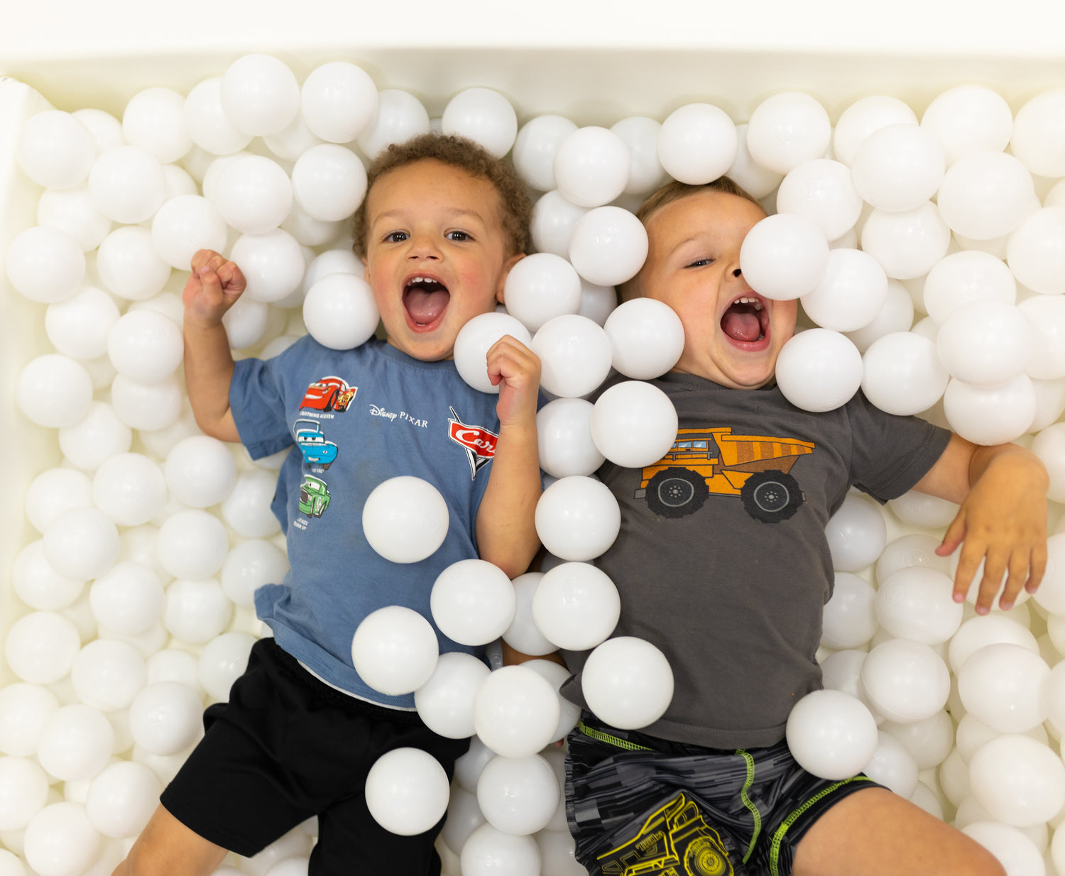 Children playing in the whimsical play zone at Goose & Giggles Play Cafe.