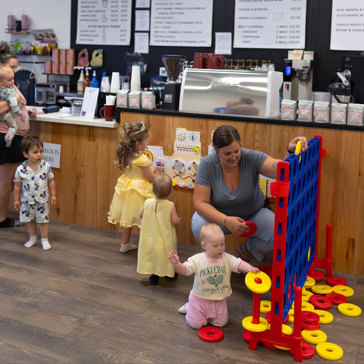Seating and kid-friendly play areas inside Goose & Giggles Play Cafe.