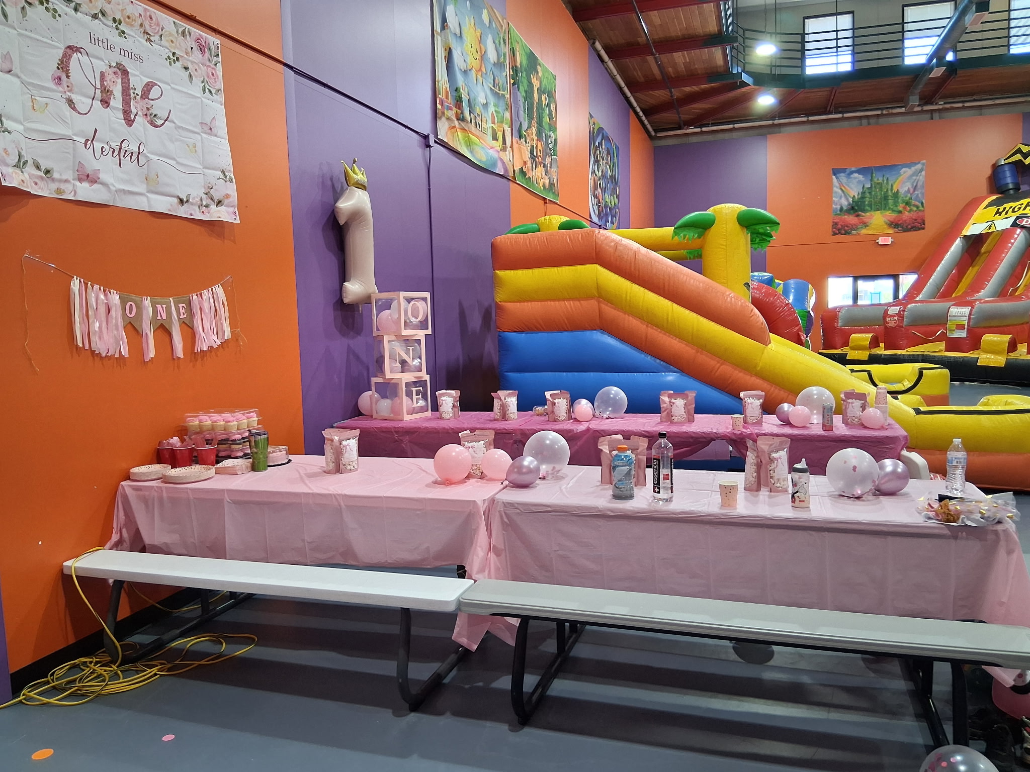 Birthday party tables set beside inflatables at Granite City Jump.