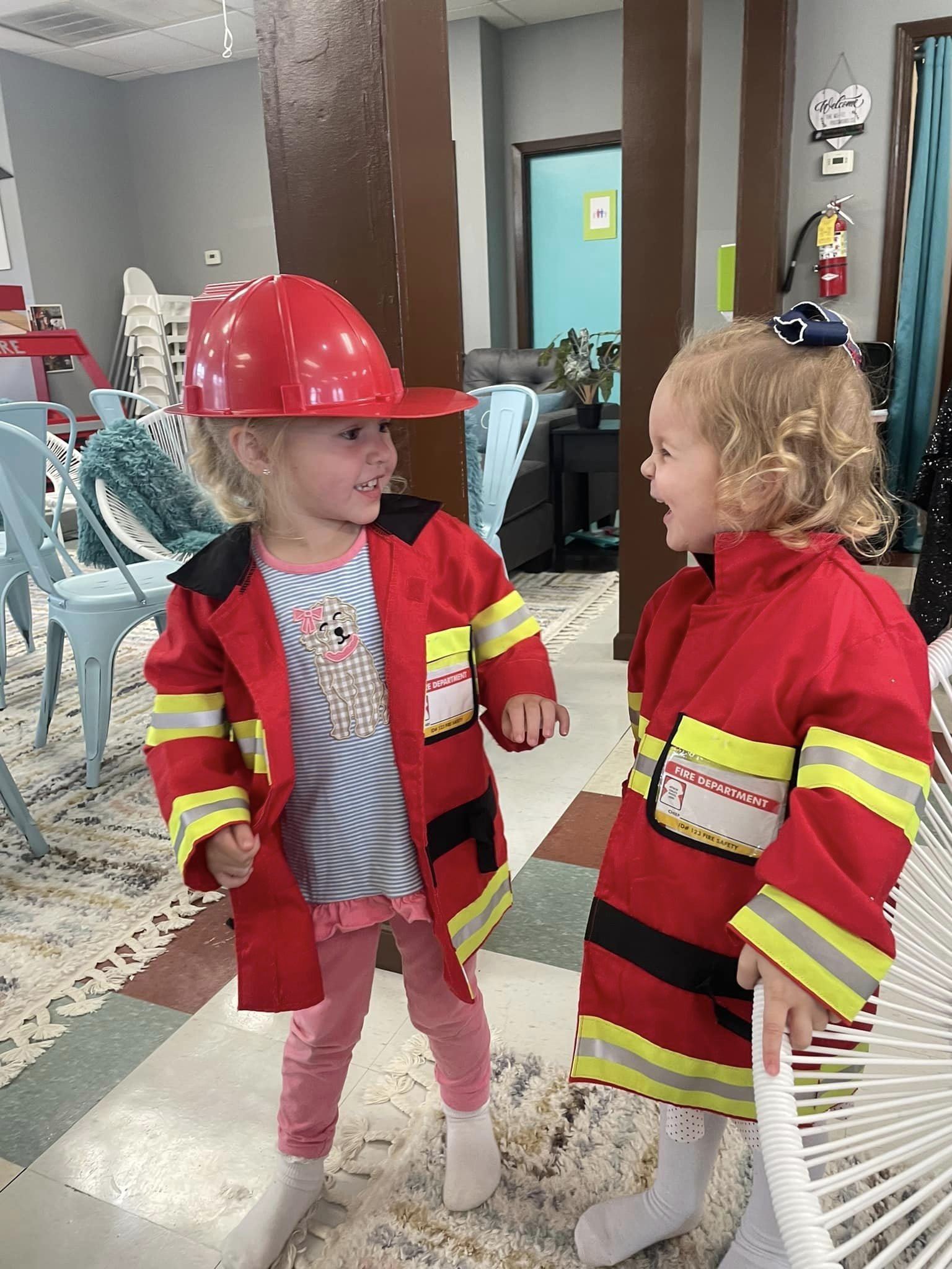 Children playing dress-up inside Happy Times Play Cafe
