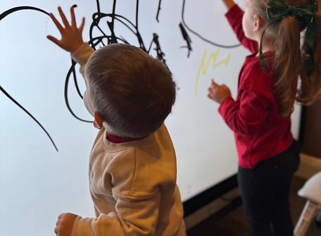 Children using a large wall activity at Hershey Children's Museum.