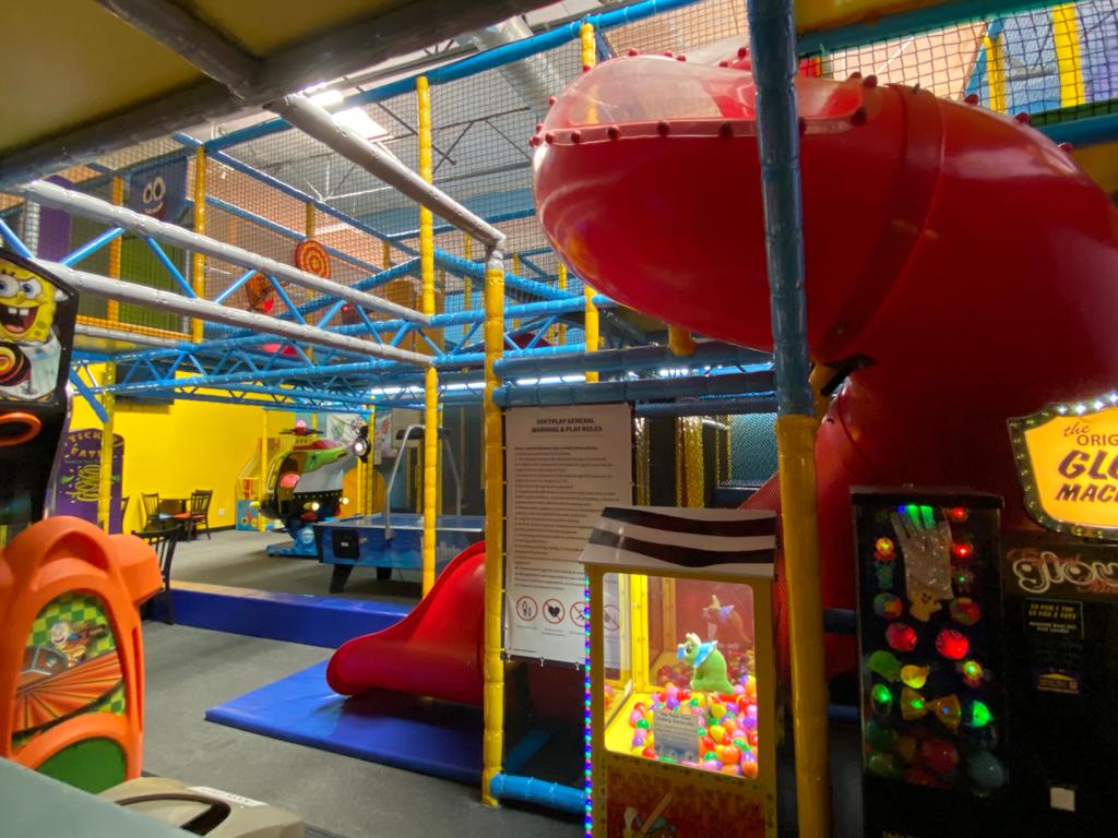 Indoor play equipment and colorful structures at Hide n Seek Bakersfield.